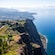 An aerial view of Cabo Girão sea cliff and Câmara de Lobos town in the distance